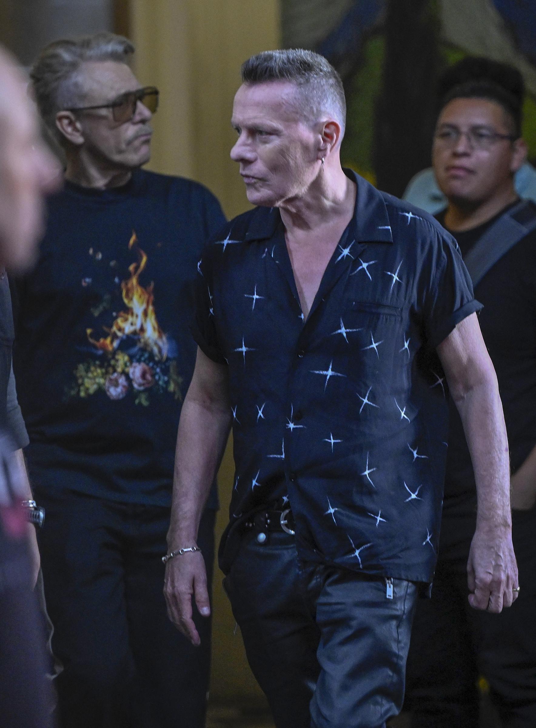 U2 drummer Larry Mullen Jr. (center) leaving the Metropolitan Palace on May 13, 2026 | Source: Getty Images