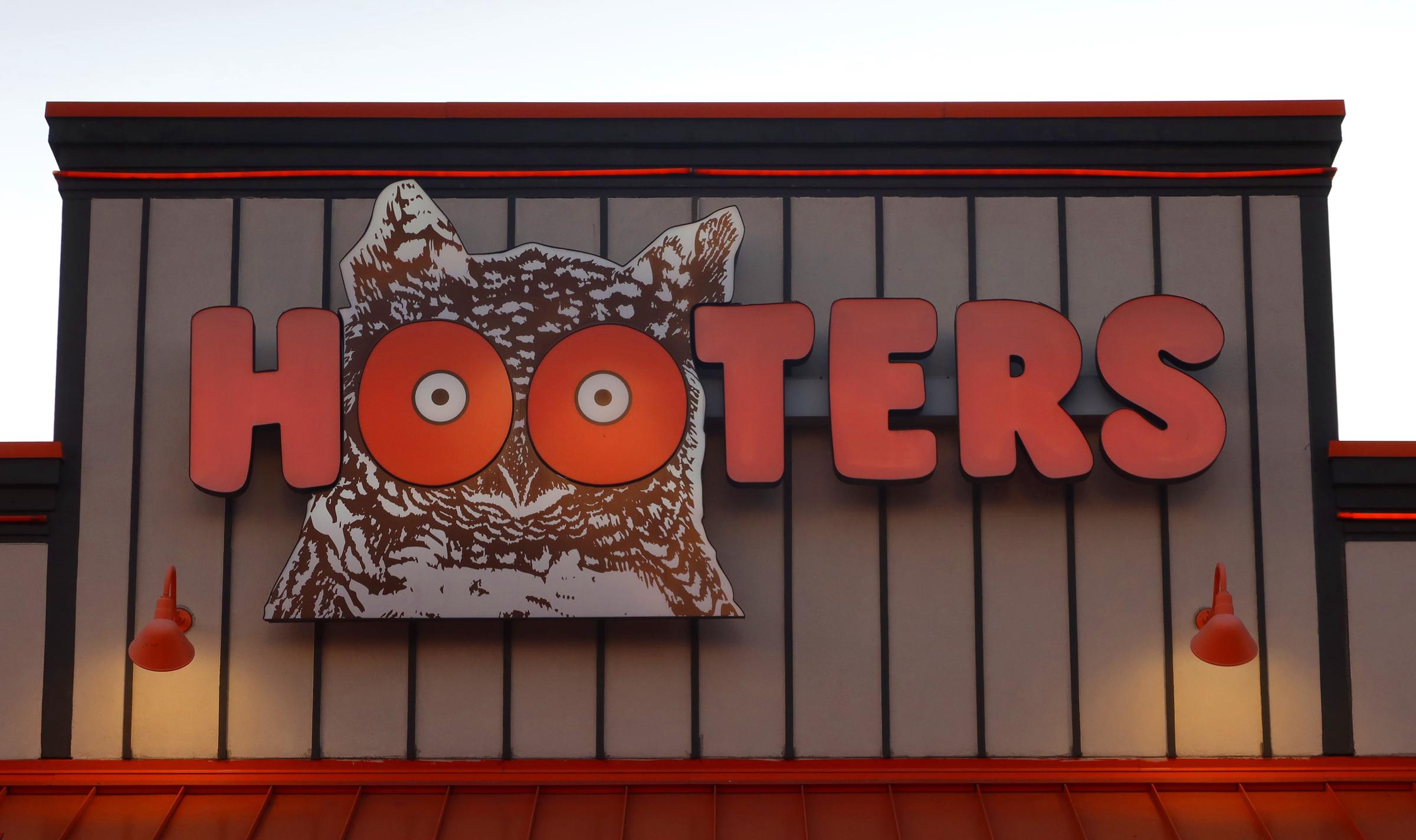 A corporate logo for a Hooters restaurant hangs on the wall of a building on April 1, 2025, in Lakeland, Florida | Source: Getty Images