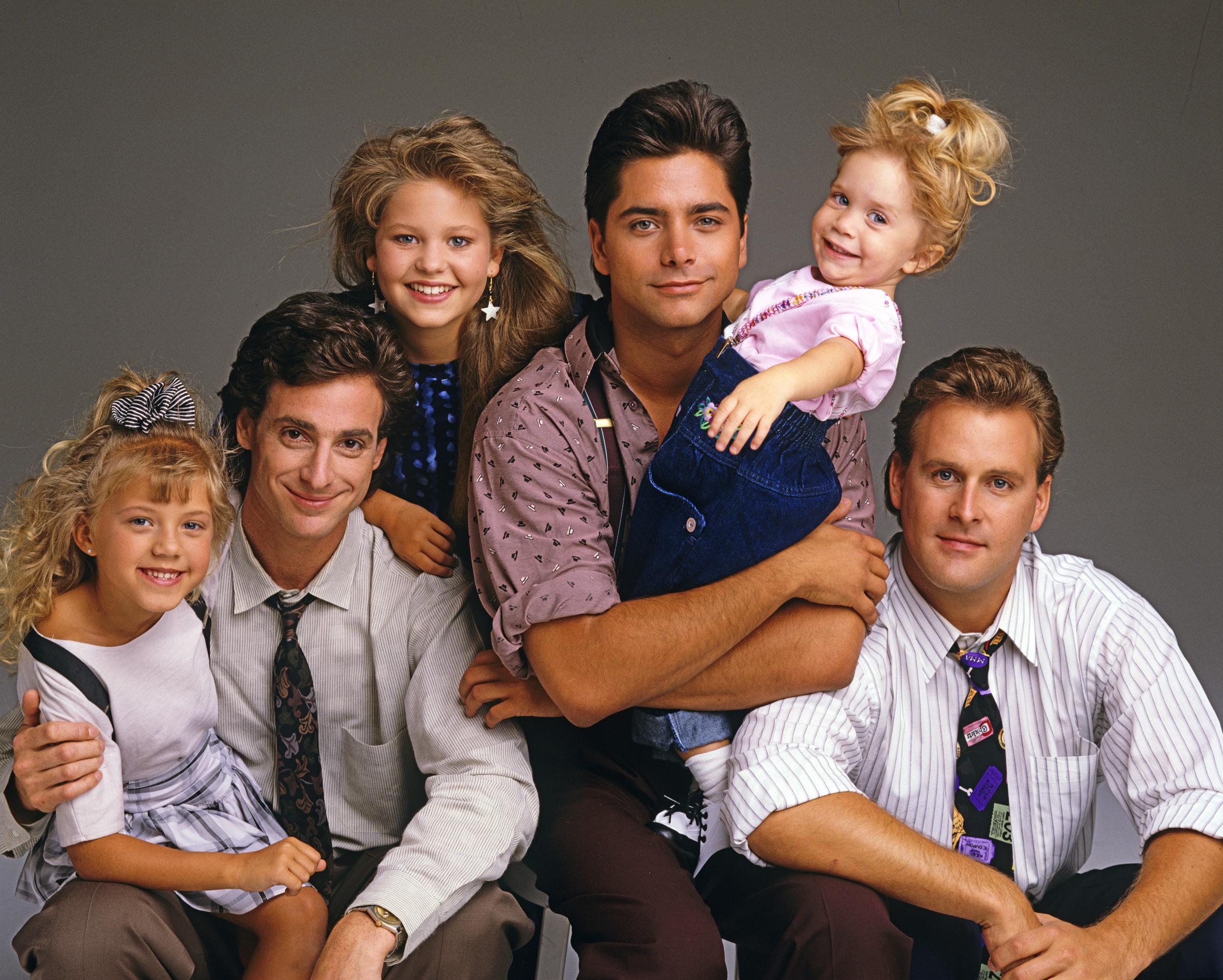 The cast of "Full House" season 3 from L to R: Jodie Sweetin (Stephanie), Bob Saget (Danny), Candace Cameron (D.J.), John Stamos (Jesse), Mary Kate/Ashley Olsen (Michelle), Dave Coulier (Joey) | Source: Getty Images