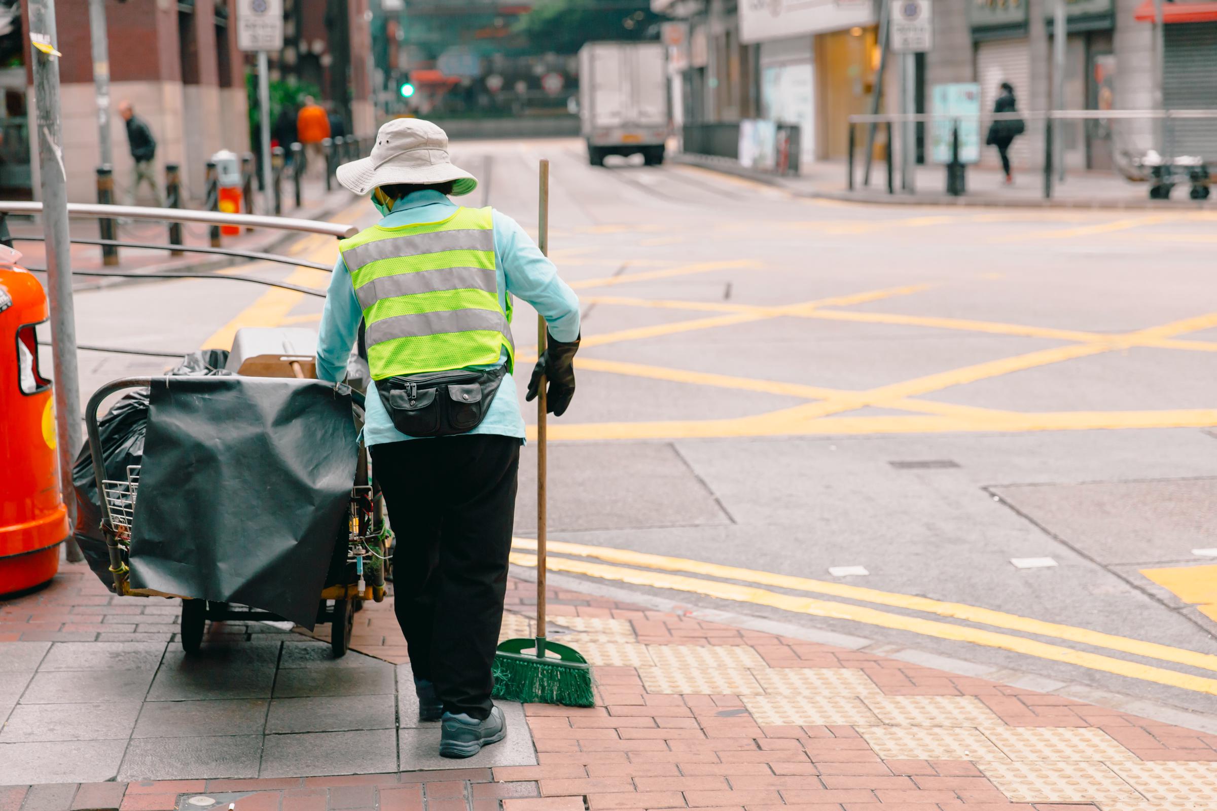 Woman cleaning the streets | Source: Shutterstock