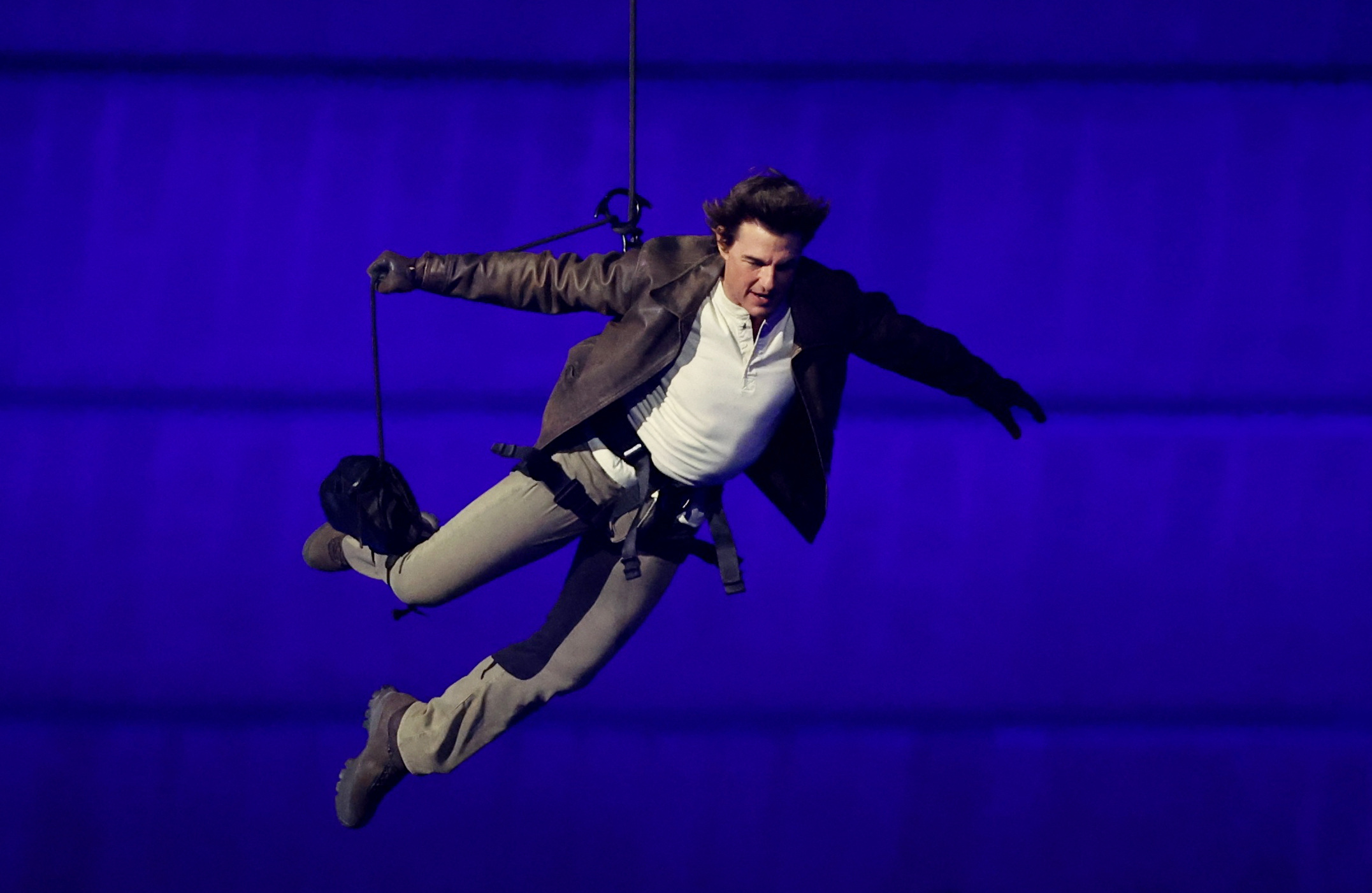 Tom Cruise jumps from the roof of the Stade de France during the Closing Ceremony of the Olympic Games in Paris on August 11, 2024 | Source: Getty Images