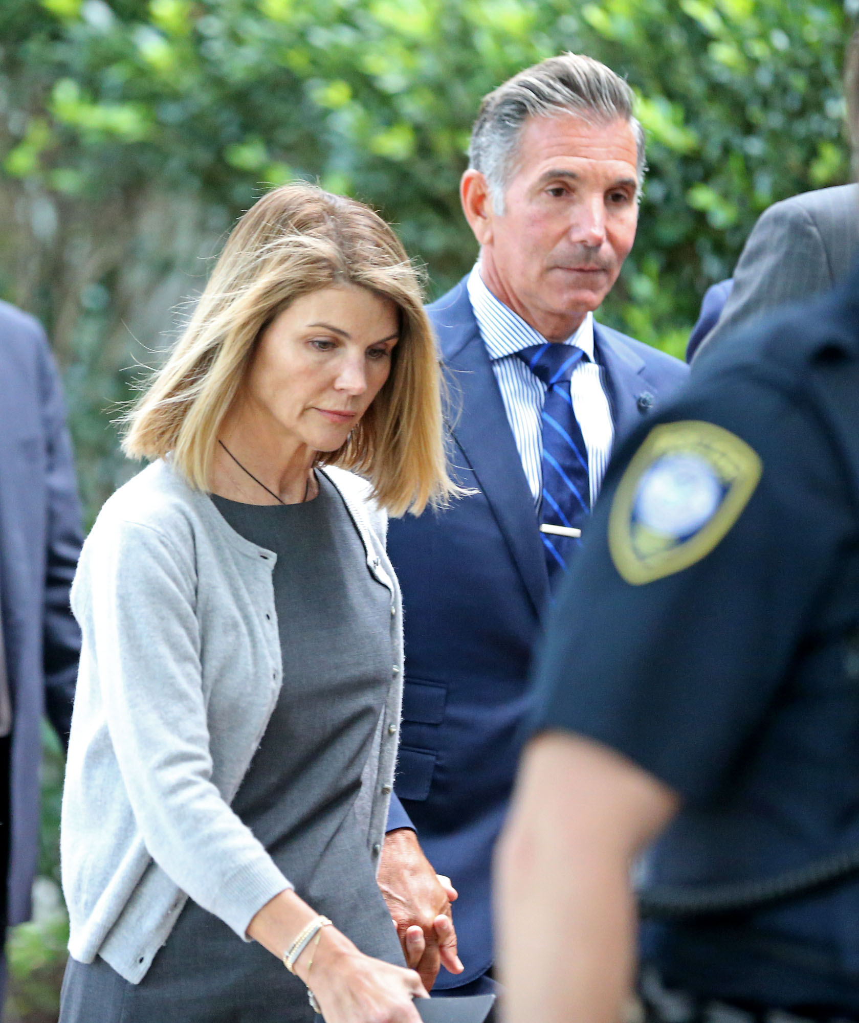 Lori Loughlin and her then-husband Mossimo Giannulli leaving Moakley Federal Courthouse after a brief hearing on August 27, 2019 in Boston | Source: Getty Images